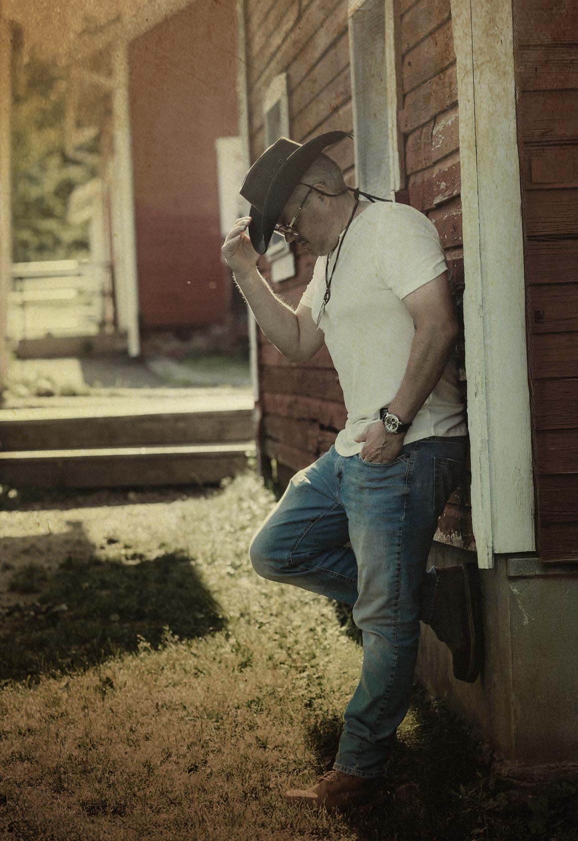 Photo of Terry leaning against a house